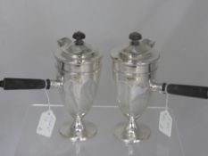 A Pair of Continental Chocolate Pots, with ebony handles and finial`s.