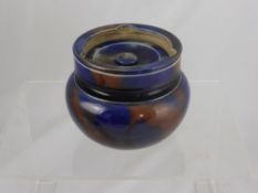 An antique pottery lustre ware tobacco jar with lid.