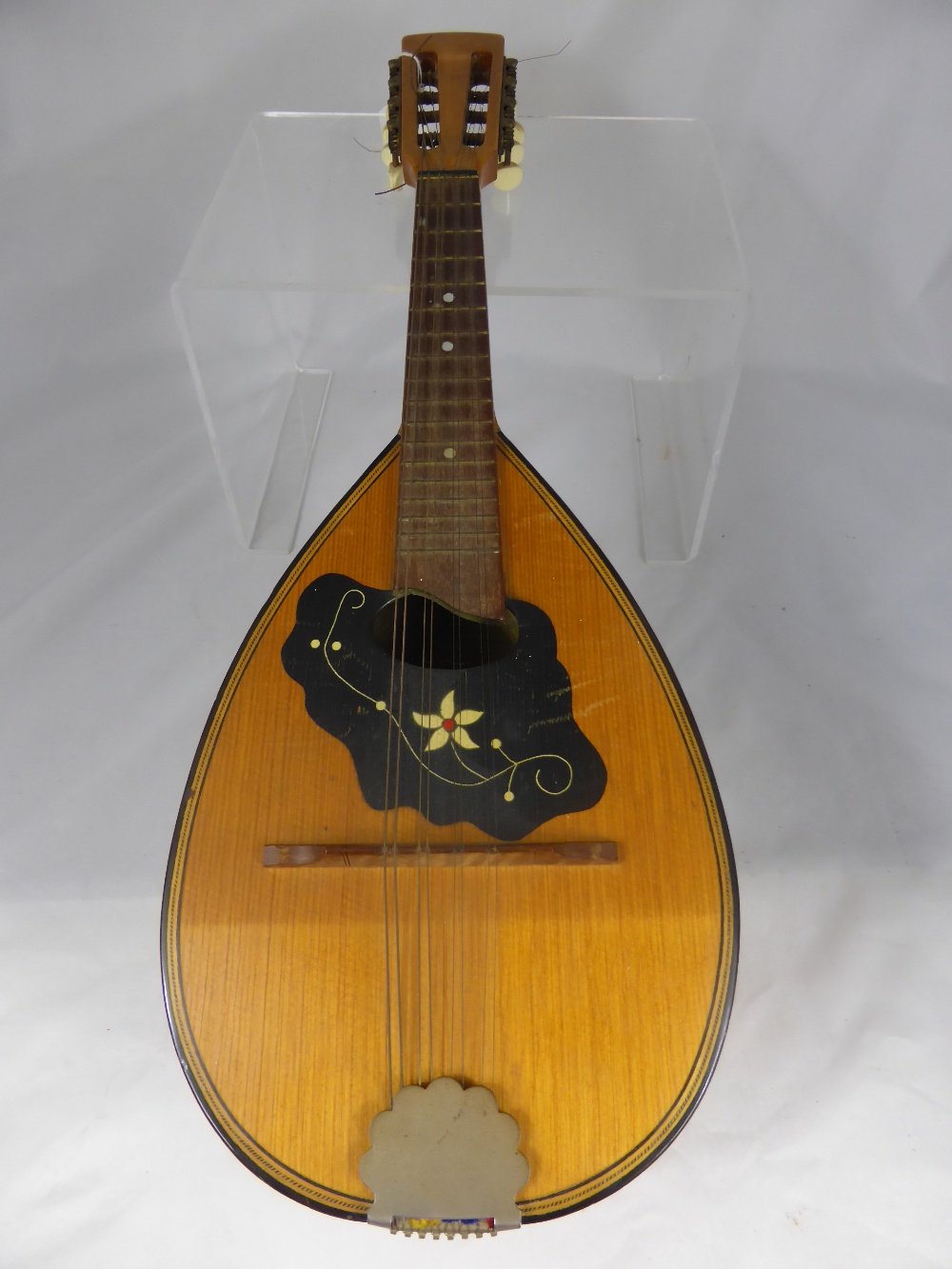 A Vintage Lignatone Czechoslavakia Round Back Mandolin with decorative banding.