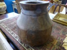 An antique wooden tribal pot, est. height 38 cms.