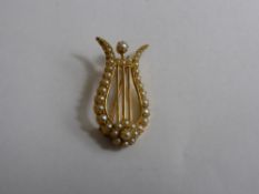 An 18 ct and Pearl Brooch in the form of a Lyre.