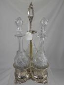 A Silver Plated Decanter Set, pierced gallery with beaded edge, with three cut glass decanters.