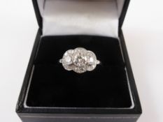 A Lady`s Platinum Three Stone Diamond Cluster Ring, centre diamond 50 pts, 1 x 15 pts & 1 x 13 pts