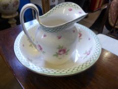 A vintage ceramic jug and washbasin, cream ground and pink rosebud decoration (2).