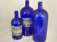 Three vintage Bristol Blue glass bottles, two being estimated at 32 cms. the other at 25 cms. (3)