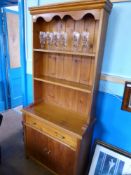 A Small Pine Cottage Dresser having two open shelves to the top with a drawer and cupboard below,