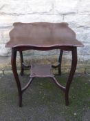 An Edwardian mahogany occasional table having a scalloped edge and an under shelf est. 58 x 58 x 60