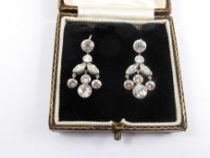 A pair of Platinum and Diamond Drop Earrings, the earrings in the form of floral pendant set with