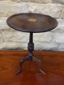 A Victorian mahogany wine table on tripod base, approx. 27 cms. diameter and 49 cms. in height.