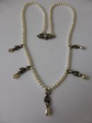A Lady`s Antique Diamond White Gold and Pearl Drop Necklace, the necklace having five floral