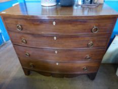 A Georgian mahogany bow fronted chest of drawers on bracket feet with four graduated long drawers,