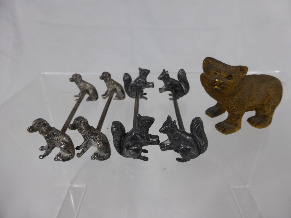 A Small Brass Figure of a Bear, together with four knife rests, two with squirrel supports and two