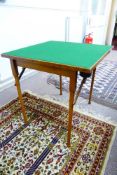 A vintage folding card table having green baise to the top with turned legs, approx. 69 x 69 x 69