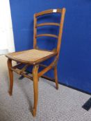 A Victorian child`s cane seated mahogany chair, possibly a folding / adjustable chair, marked