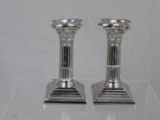 A pair of Silver Plate Corinthian style candlesticks, approx. 15 cms high.