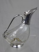 A vintage silver plate and glass claret jug in the form of a bird.