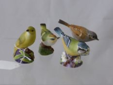 Four Royal Worcester Figures of Birds comprising a blue tit, a wood warbler, a gold crest and a