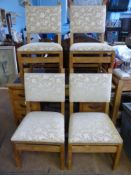 A set of eight banqueting chairs being light oak, the seats and backs being covered in a light