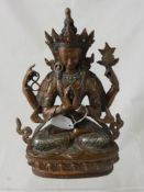 An Antique Bronze Sino -Tibetan Deity, the figure seated in a contemplative pose on a lotus leaf