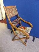 A Victorian mahogany folding / campaign chair having a tapestry panel to the back with spindles