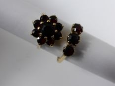Two Lady`s 9 ct hallmark Yellow Gold Garnet Rings. Cluster Ring size M, three stone ring size O,