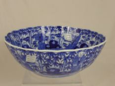 An Antique Blue and White Fluted Punch Bowl, depicting figures in a garden together with an antique