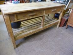 A large antique pine workbench / table fitted with two drawers and a slatted under shelf, approx.