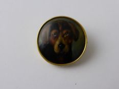 An Antique Hand Painted Porcelain Brooch depicting an endearing hound, the brooch set in a 9 ct
