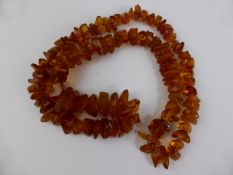 String of Rough Amber Beads, approx. 70 cms. in length, 88 gms. weight.