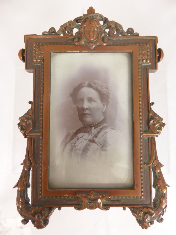 A Victorian Parisian Copper Photo Frame, with mask and scroll decoration, approx 15 x 9 cms.