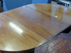A Georgian style mahogany dining table being a D shaped extending table on slightly tapered legs,