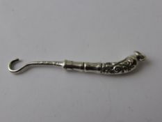 A Miniature Solid Silver Button Hook with chased handle. Birmingham hallmark dated 1902.