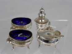 A Solid Silver Cruet Set, including mustard pot, two salt cellars with blue glass liners together