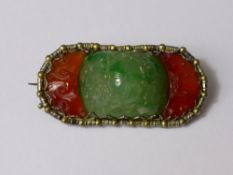 A Chinese Green Jade and Orange Stone Brooch, the green jade carved in high relief with monkeys