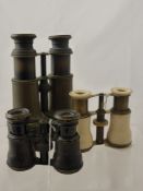 A pair of vintage binoculars together with two pairs of vintage opera glasses, one possibly being