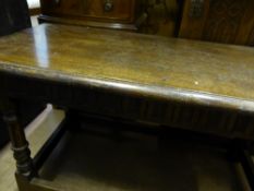 A Victorian dark oak coffee table on part turned legs with stretchers, the table having a decorated