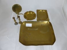 A brass trench art ashtray, depicting an airship, two other ashtrays, a miniature brass tilt top