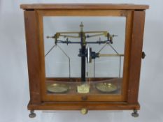 A set of laboratory analytical scales by Baird & Taylor, Essex, SA / 907 / 309, in a glass case