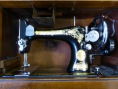 A vintage Singer Sewing Machine in the original case.