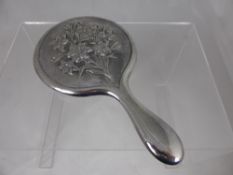 A Solid Silver Lady`s Hand Mirror, beautifully embossed with a spray of lilies, Birmingham