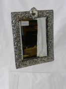 An Ornate Victorian Solid Silver Frame Table Mirror, the leather backed mirror having floral