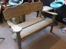 A vintage wooden garden bench having a shaped back decorated with three birds, the bench also