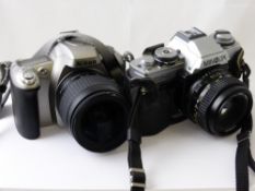 A Nikon F55 35 mm camera together with a Minolta XG-M camera.