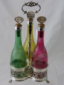 A Silver Plated Three Bottle Decanter Set, the galleried holder containing three coloured bottles