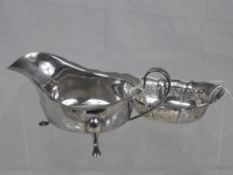 A solid silver sauce boat, Birmingham hallmark, mm B E S & Co. together with a miniature fruit