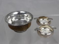 An antique Indian silver and wood drinking vessel together with two vine leaf engraved ashtrays,