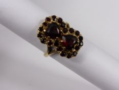 A Lady`s 9 ct hallmark Yellow Gold double heart garnet ring, size M, approx 5.8 gms.