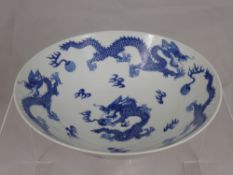 An Antique Porcelain Blue and White Bowl, depicting chasing dragons, flaming pearls of wisdom and