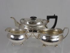 A Solid Silver Tea Trio, comprising tea pot, twin handled sugar bowl and a milk jug all on ball