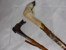 A walking stick with a goats hoof handle and various badges including Jersey, Belgium, Venice,